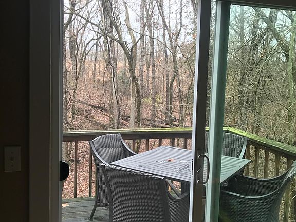 View from kitchen to back deck and trees/woods behind