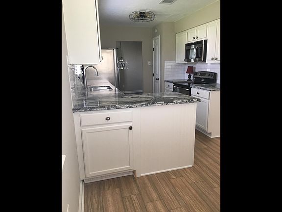 Granite, Subway Tiles, and Wood Plank Tile Flooring