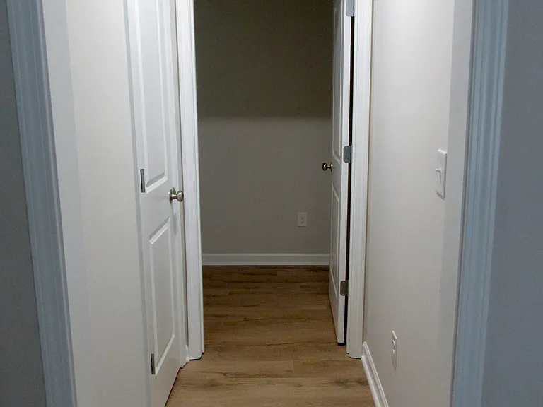 Hall near front door leading to laundry room & closet pantry
