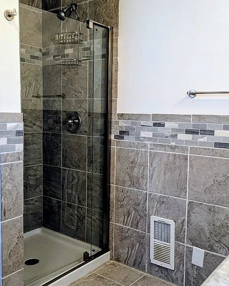 Spacious tiled shower.