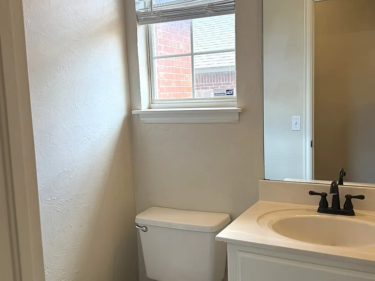 Half bathroom off the kitchen for a quick bathroom stop. Leads in from the garage. Updated color in this room too!