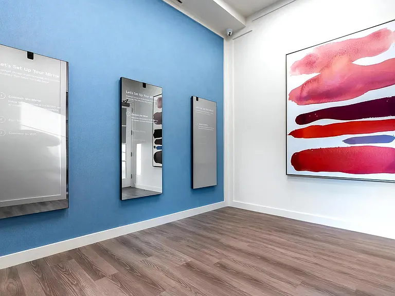 Resident Studio with Interactive Fitness Mirrors and Bold Art