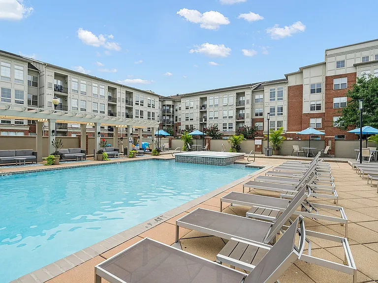 Experience ultimate relaxation at this luxury apartment's stunning pool area.
