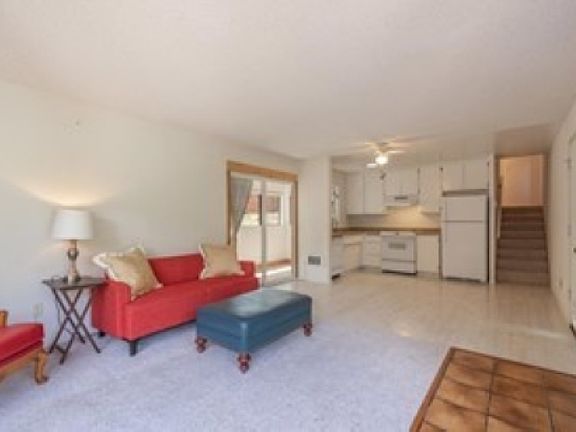 Open floor plan, with stairs to 2nd floor bedrooms; access to enclosed patio/sunroom.