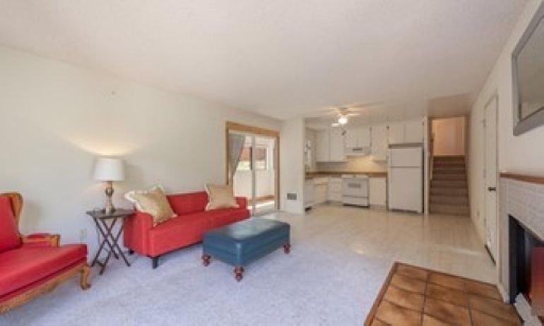 Open floor plan, with stairs to 2nd floor bedrooms; access to enclosed patio/sunroom.
