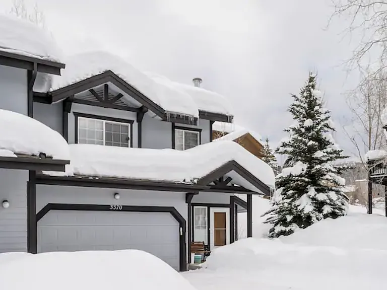 Heated garage can fit a car. The driveway that can fit 4 additional cars. It's hard to see, but you can set up a pretty good sledding course off to the right in the yard :-)