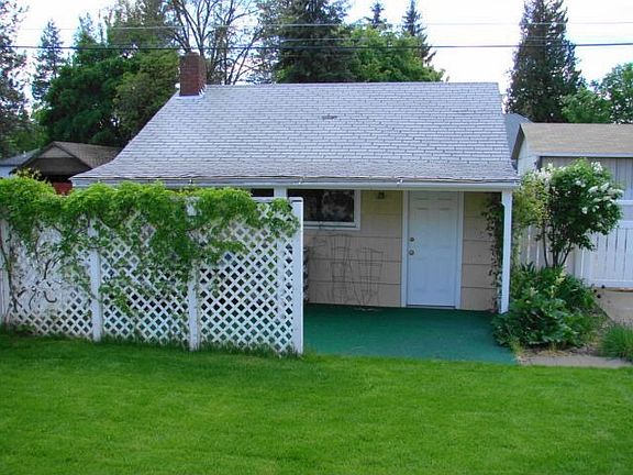 garage with fence and patio