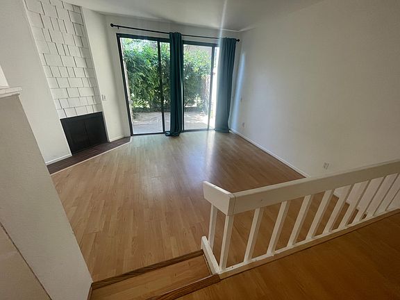 Living room with fireplace and slider to private patio