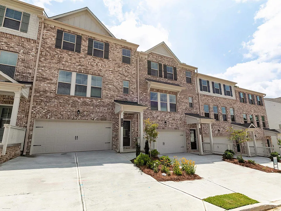 Exterior shot of the Kingston floor plan, a three-story townhome with a private driveway and attached garage.