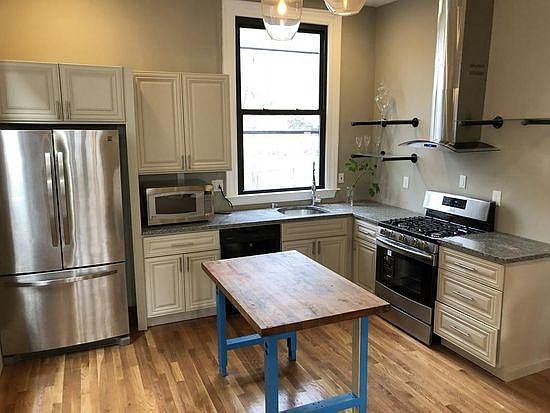 Kitchen - refrigerator, stove. Table is part of the room
