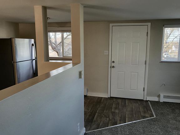 In the living room looking out on the front door and kitchen divider.