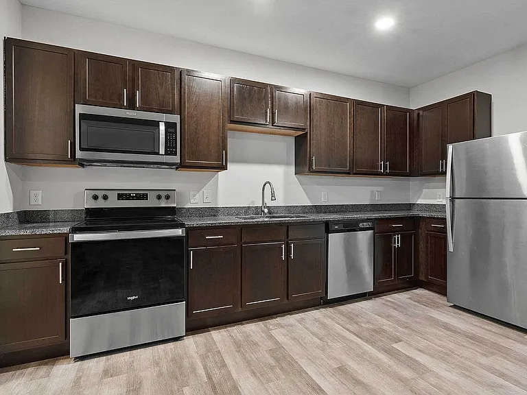 Enjoy modern design in this open-concept two-bedroom apartment featuring a full kitchen with stainless-steel appliances, dark cabinetry, and luxury vinyl flooring. Enjoy modern design in this open-concept two-bedroom apartment featuring a full kitchen wit