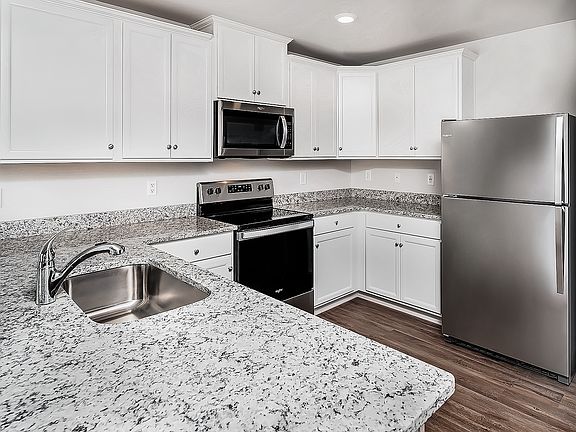 White cabinetry with hardware provides tons of storage