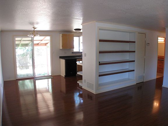 Built-in bookcase and rich laminate flooring ads elegance and functionality. 