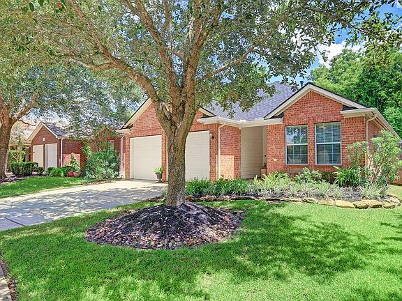 This home has charming curb appeal with a lush shaded yard and rock lined beds.