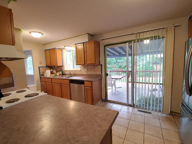 Kitchen with sliding door to backyard deck