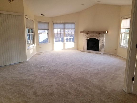 Fireplace and many windows with a beautiful view in the livi