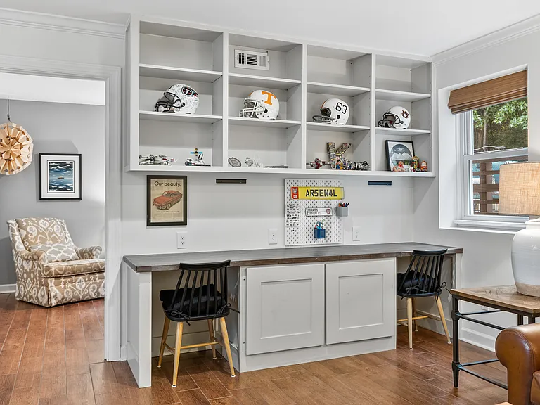 Second living room with two desk spaces, comfortable leather couch and lounge chair, Smart TV, and a ceiling fan. Perfect spot for movie night.