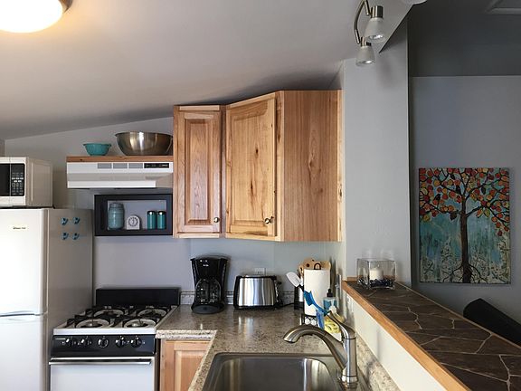 Kitchen with gas range, frig and microwave