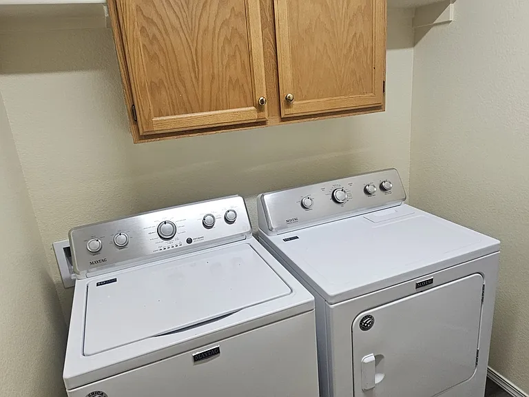 laundry room includes Maytag washer and dryer
