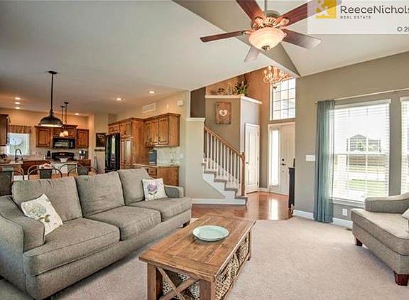 This angle from the great room displays the hardwood floors in the entry way that continue throughout the rest of the main floor.  This view also shows the 2 story entry which also allows natural light to shine in.