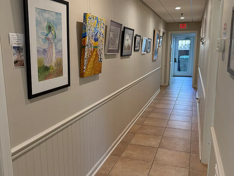 Art from our talented residents! Men's and women's dressing rooms with showers on left side of hall. Right side has library and game room.