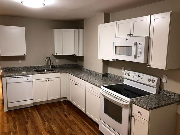 Features a newly renovated spacious kitchen with matching white appliances and new hardwood floors.