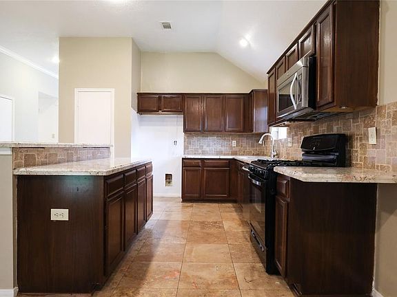 Beautiful cabinets, granite countertops and modern appliances.