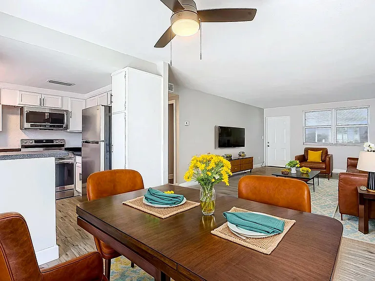 Inviting open-concept living area featuring a modern kitchen, stylish dining space, and cozy seating in a bright, airy apartment. Inviting open-concept living area featuring a modern kitchen, stylish dining space, and cozy seating in a bright, airy apartm