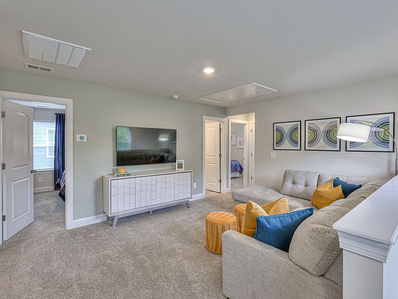 The upstairs loft separates the secondary bedrooms from the primary suite.