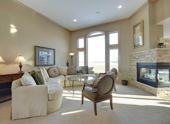 Peninsula fireplace and stunning window wall highlight the Great Room.