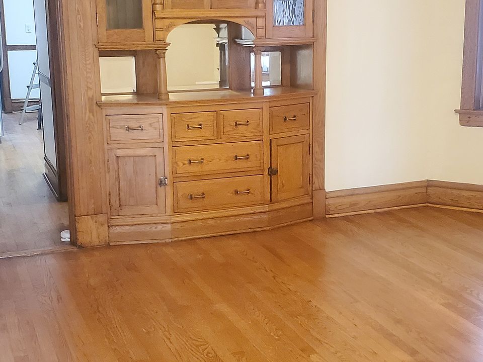 Dining-room: Built-in oak hutch/china cabinet, oak beamed ceiling, hallway to Bedrooms & Kitchen on left.