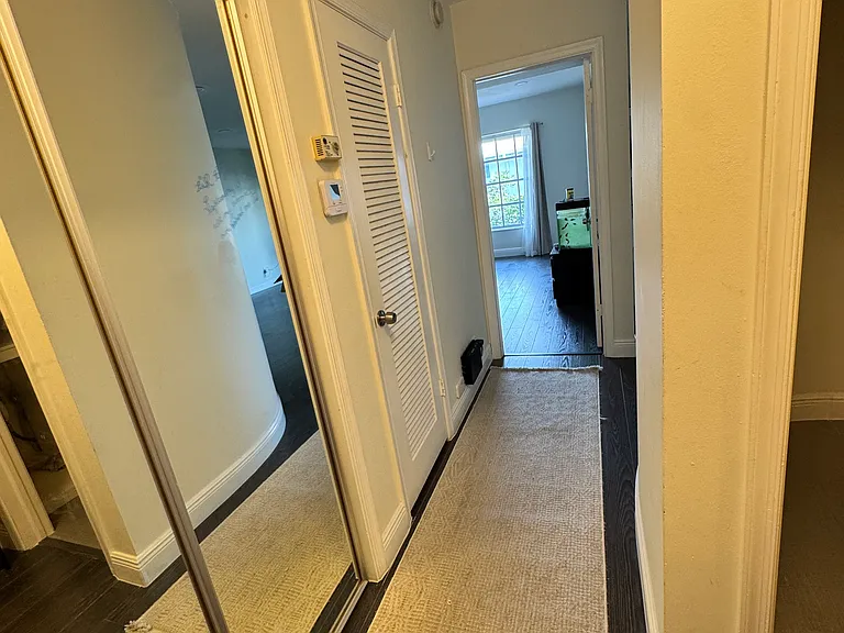front door entrance way, looking into primary bedroom