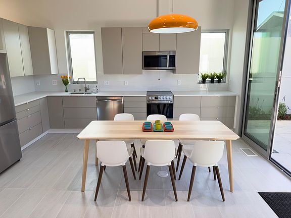 The kitchen easily accommodates 8 chairs.