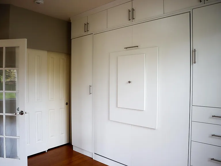 Floor to ceiling, wall to wall, custom closets with wall bed and table.
