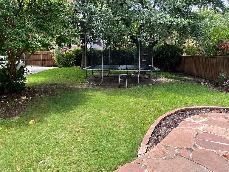 Large backyard with electric security gate