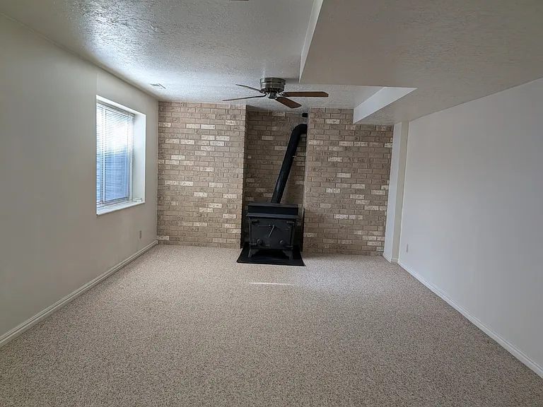 Basement family room. Note: Wood stove is non-operable.