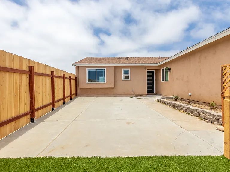 Private gated frontyard with cement and turf ( this is separate from driveway)
