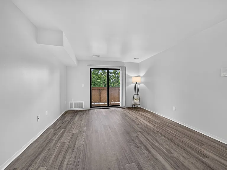Spacious living room at Woodland Villa Apartments in Westland, MI.