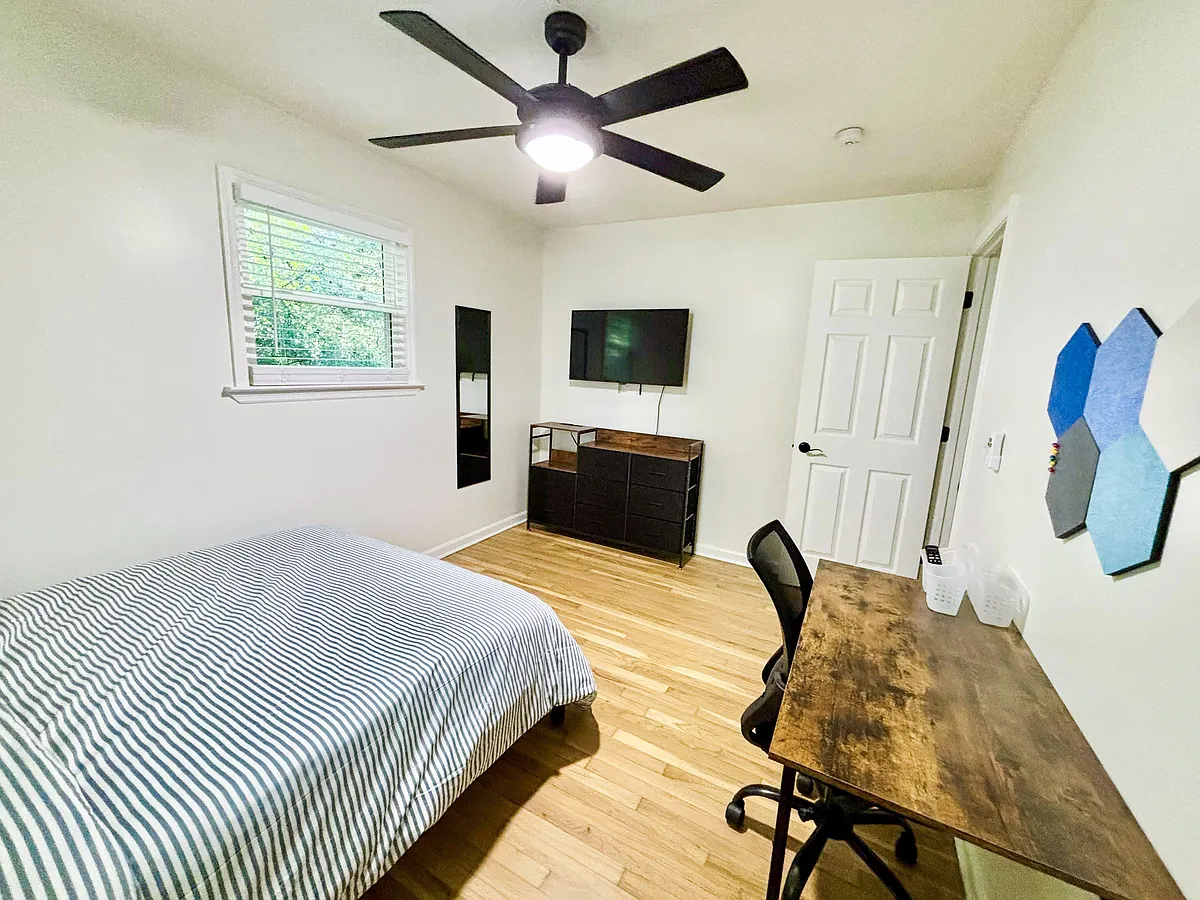 Spacious bedroom with full sized bed, mounted smart TV, desk & bulletin board, and full length mirror! - Candace Ln SE