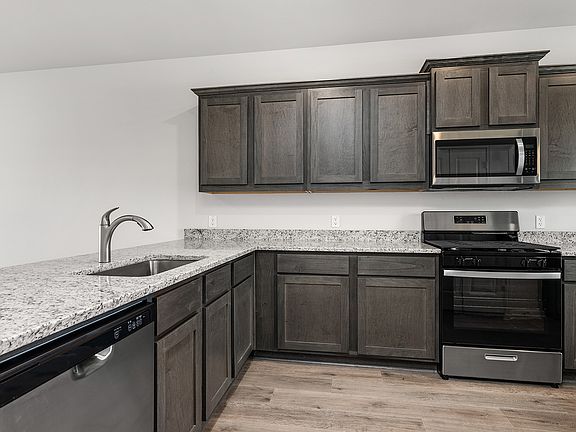 The kitchen has gorgeous brown cabinetry.