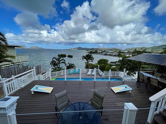 Spacious decks transition the main home to the pool area