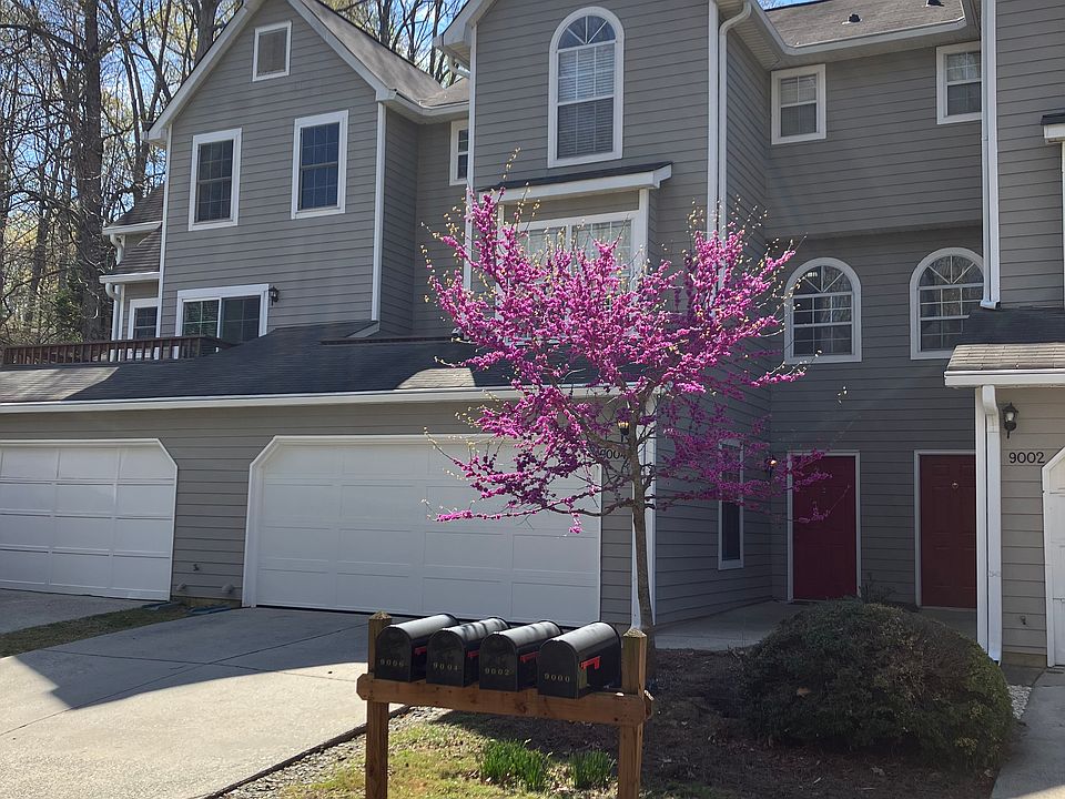 Front of House w/flowering Red Bud tree and new garage door. New front door to be installed early July ''25.