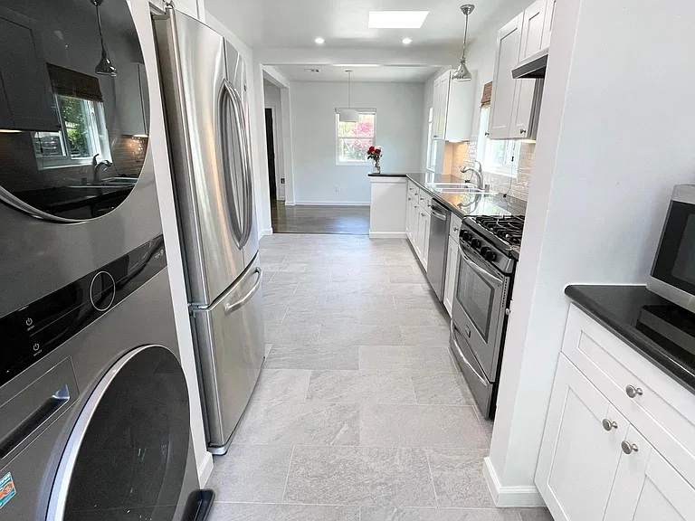 Kitchen and pantry area with smart washer / dryer.