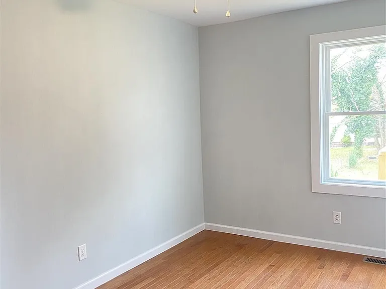 Bedroom #2 with window view of backyard