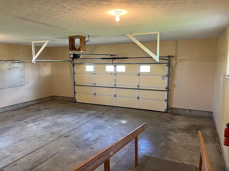 Garage
Large 16 foot garage door
with new opener
Handicap ramp in foreground. 
Pegboard on left
Garage: 27'5' wide by 23.5" deep, ~650 sq ft.
Ceiling height is about 9 feet