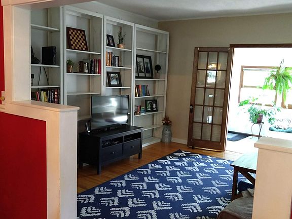 Living room with french doors to small sunroom.