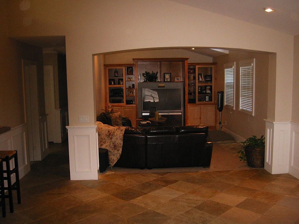 Foyer looking into livingroom with built in entertainment theater with surround sound