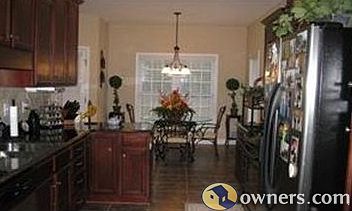 Kitchen has tile floors & granite