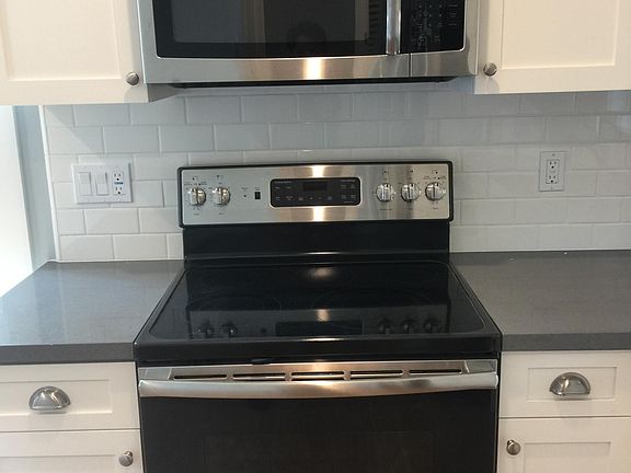 Built-in Microwave and Electric Range (GE).